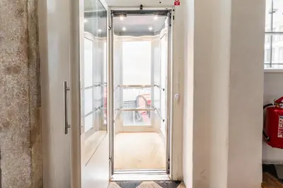 a glass door leading into a room with a hallway at Charming Apartment in Lesser Town in Prague