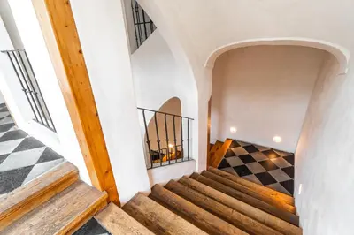 a staircase in a house with a checkered floor at Charming Apartment in Lesser Town in Prague
