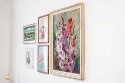 a group of framed pictures on a wall at Charming Apartment in Lesser Town in Prague