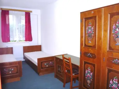 a bedroom with a bed and a desk and a window at Sport areál Samopše in Vraník