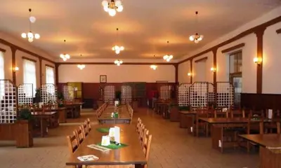 a large room with wooden tables and chairs at Sport areál Samopše in Vraník