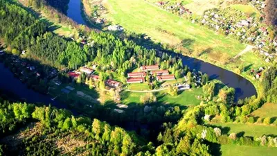 an aerial view of a house on a hill next to a river at Sport areál Samopše in Vraník