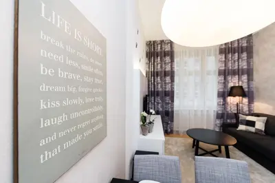 a living room with a large poster on the wall at Modern Apartment Charvatova in Prague