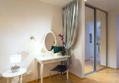 a bathroom with a dressing table and a mirror at Modern Apartment Charvatova in Prague