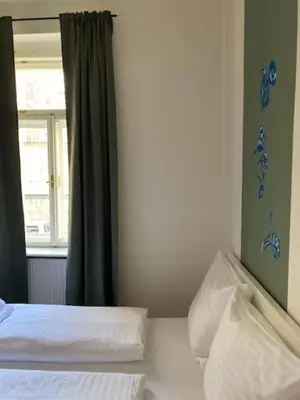 a bedroom with a bed and a window at Erbenova Apartments in Prague