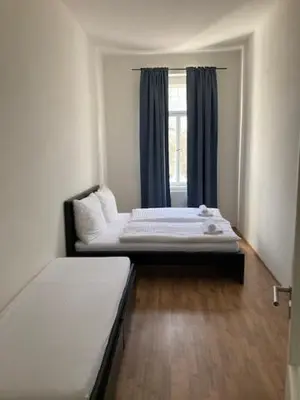 a room with two beds and a window at Erbenova Apartments in Prague