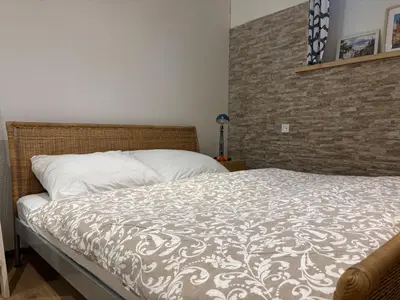 a bedroom with a bed with a brown and white comforter at Flat white flat in Prague