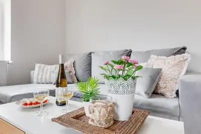 a living room with a couch and a table with wine glasses at Modern, bright and spacious apartment in Prague