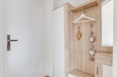 a hallway with a wooden door with a heart on the wall at Modern, bright and spacious apartment in Prague