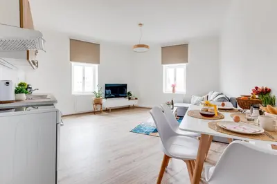 a kitchen and living room with a table and chairs at Modern, bright and spacious apartment in Prague