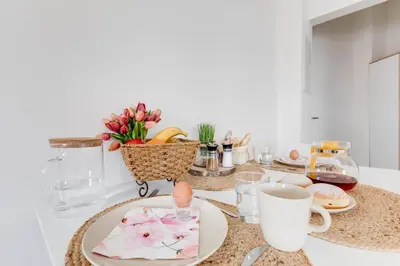 a table with plates and cups on a counter at Modern, bright and spacious apartment in Prague