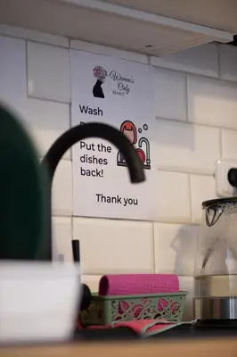 a kitchen counter with a sink and a faucet at Women's Only Hostel - Female Only in Prague