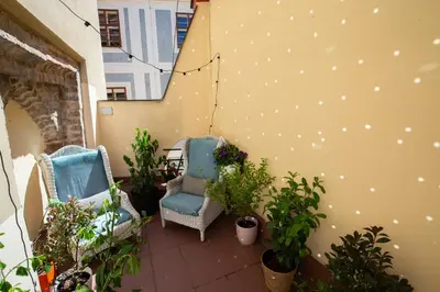 two chairs sitting on a balcony with plants at Women's Only Hostel - Female Only in Prague