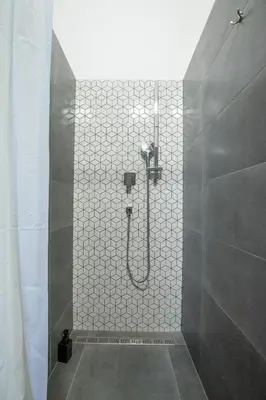 a shower with a shower head in a bathroom at Women's Only Hostel - Female Only in Prague