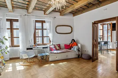 a woman sitting on a couch in a living room at Women's Only Hostel - Female Only in Prague