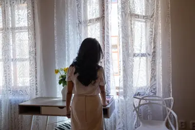 a young girl standing in front of a window at Women's Only Hostel - Female Only in Prague