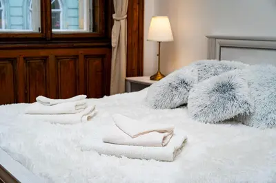 a bed with two towels on top of it at Imperial Deluxe Suite in Prague