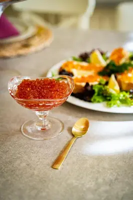 a table with a plate of food and a bowl of sauce at Imperial Deluxe Suite in Prague