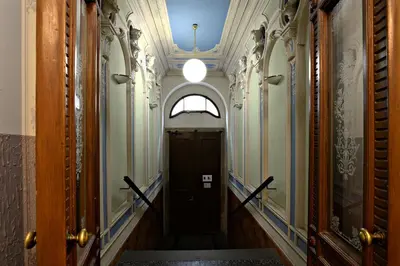 a hallway with a black door and a ceiling at Imperial Deluxe Suite in Prague