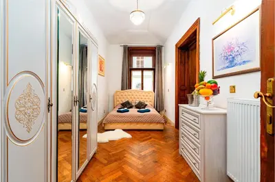a bathroom with a vanity and a chair and a mirror at Imperial Deluxe Suite in Prague
