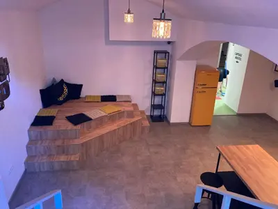 a bedroom with a bed and a desk and a table at Capsule hostel Erbenova in Prague