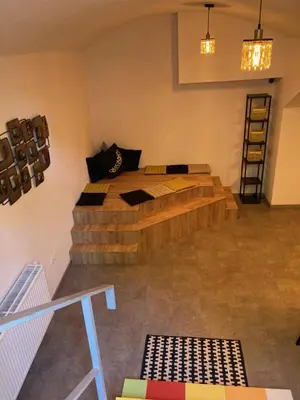 a bedroom with a wooden bed in a room at Capsule hostel Erbenova in Prague