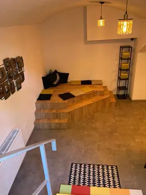 a bedroom with a wooden bed in a room at Capsule hostel Erbenova in Prague