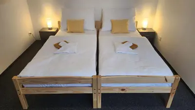 a bed in a room with two pillows on it at Penzion-Dubno in Dubno
