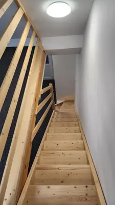a staircase in a room with wooden floors at Penzion-Dubno in Dubno