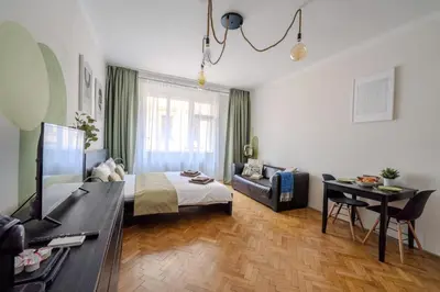 a bedroom with a bed and a desk and a couch at Cozy Prague Apartment in Prague