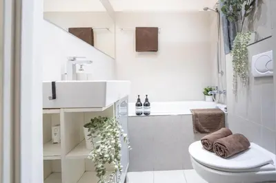 a small bathroom with a toilet and a sink at Cozy Prague Apartment in Prague