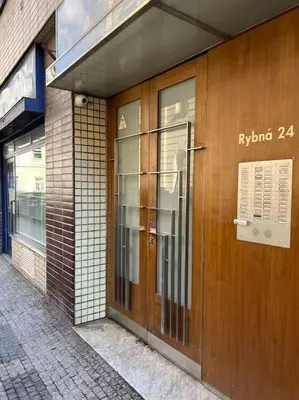 a building with a wooden door on a street at Cozy Prague Apartment in Prague