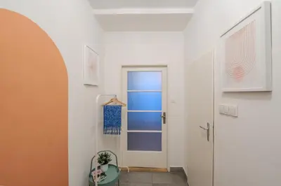 a hallway with a door and a toilet in a room at Cozy Prague Apartment in Prague