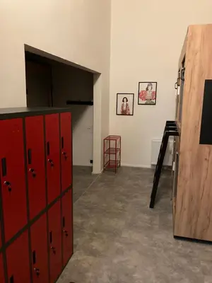 a room with red cabinets and a ladder in it at Capsule hostel Žižkov tower in Prague