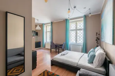 a bedroom with a bed and a mirror at Vals Garden Apartment in Prague