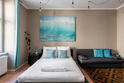 a bedroom with a bed and a couch at Vals Garden Apartment in Prague