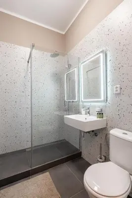 a bathroom with a toilet and a sink at Vals Garden Apartment in Prague