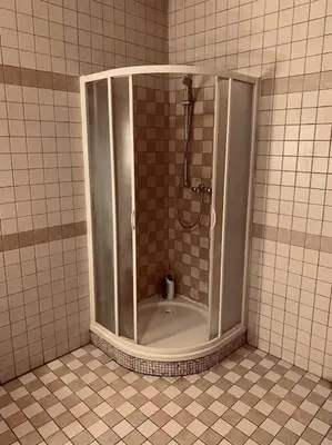 a shower in a tiled bathroom with a tub at soukromý apartmán Přemysl in Nymburk
