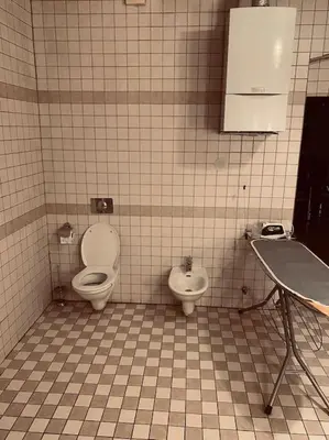 a tiled bathroom with two toilets and a sink at soukromý apartmán Přemysl in Nymburk