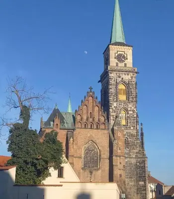 a large church with a clock tower on a building at soukromý apartmán Přemysl in Nymburk