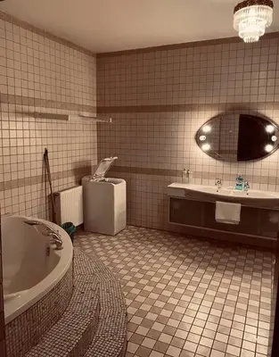 a bathroom with a tub and a toilet and a sink at soukromý apartmán Přemysl in Nymburk