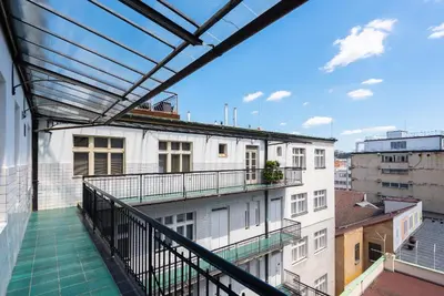 a balcony with a view of a building at New modern apartment 5. floor in Prague