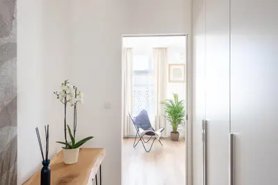 a living room with a refrigerator and a chair at New modern apartment 5. floor in Prague
