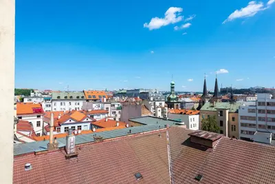 a view of a city with roofs and buildings at New modern apartment 5. floor in Prague