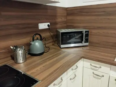 a kitchen counter with a toaster oven and a microwave at Apartmány Svatá in Zdice