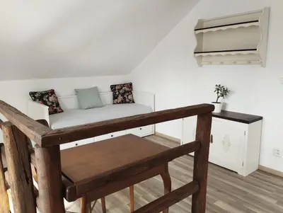 a room with a couch and a bench in a room at Apartmány Svatá in Zdice