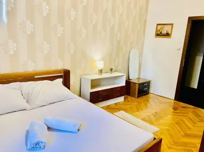 a table with a chair and a picture on the wall at Hotel Apartment in Prague 2 Square in Prague