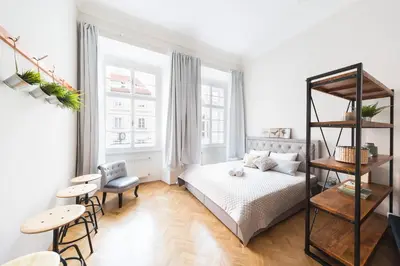 a bedroom with a bed and a table and chairs at Bohéme Apartments Old Town Square in Prague