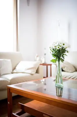 a vase of flowers on a table in a living room at Bohéme Apartments Old Town Square in Prague