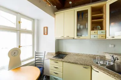 a kitchen with a table and a laptop on the counter at Bohéme Apartments Old Town Square in Prague